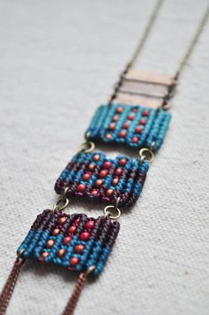 three beaded necklaces on a white surface