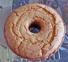 a round cake sitting on top of a cooling rack