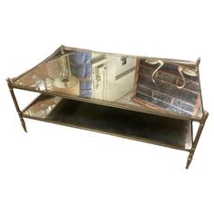 a metal and glass coffee table with an old oven in the backgroung