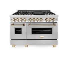 a silver stove with two ovens and gold knobs on the front, against a white background