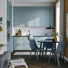 a kitchen and dining room with blue cabinets