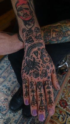 a person with tattoos on their hands and fingers