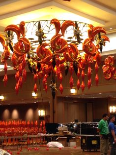 an elaborate chandelier hangs from the ceiling in a large room filled with tables and chairs