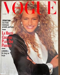 a woman with long hair on the cover of a magazine, smiling at the camera