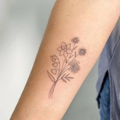 a woman's arm with flowers on it