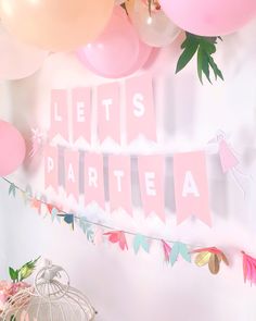 pink and white party decorations with balloons