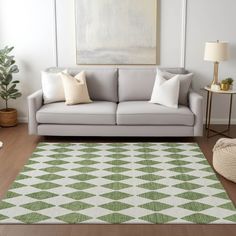 a living room area with a couch, rug and two lamps on the side tables