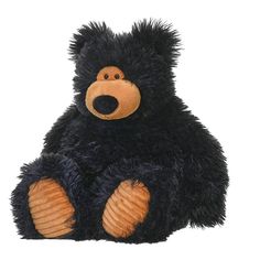 a black teddy bear sitting on the ground