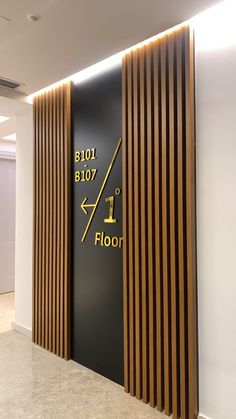 the entrance to an office building with wood slats on the wall and flooring