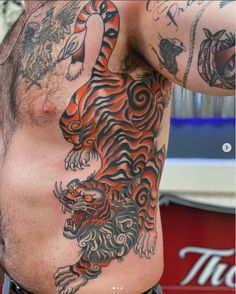 a man with a tiger tattoo on his chest