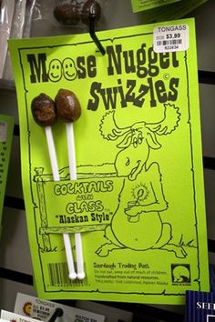 some kind of candy on a stick in front of a sign that says moose nugge swizzers