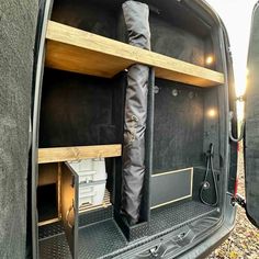 the back end of a van with its cargo door open and boots in the trunk