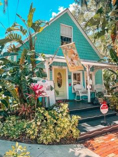 a blue house with a sign in front of it