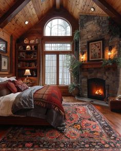 a bedroom with a bed, fireplace and large rug on the floor in front of it