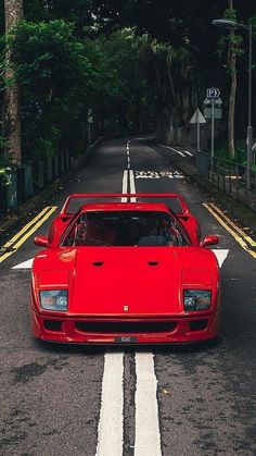 a red sports car is parked on the side of the road