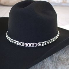 Silver and Rhinestone Bling Hat Band for cowgirls. Dress up your cowboy hat with this gorgeous hat jewelry!This rhinestone strand hatband comes with 3 layers of clear rhinestones set on silver metal. It is adjustable with a metal clasp in the back. Fits up to size 7 1/2 hat. * Hat not included. Adjustable Western Jewelry For Party, Adjustable Western Style Party Jewelry, Adjustable Western Style Jewelry For Parties, Western Style Silver Party Jewelry, Western Silver Jewelry For Parties, Western Style Silver Jewelry For Party, Adjustable Rhinestone Hat Bands For Western-themed Events, Adjustable Silver Hat Band For Rodeo, Adjustable Bling Hat For Country Events