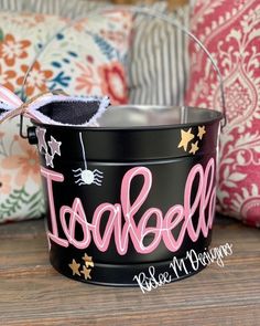 a black bucket with the word toobeet painted on it sitting on a wooden table