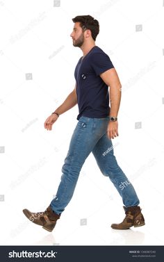 a young man walking with his foot in the air, looking back at the camera