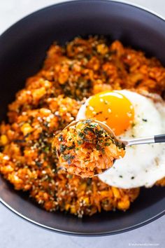 a bowl filled with rice and fried eggs