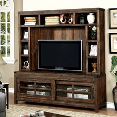 a living room with a large entertainment center and a flat screen tv on top of it