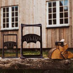 two pieces of wood sitting next to each other on top of a wooden table in front of a building