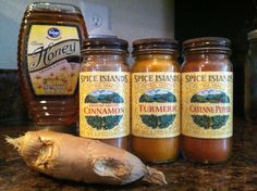 three jars of spices sit on a counter