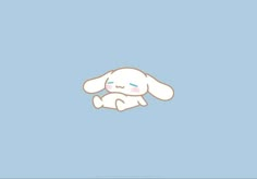 a white bunny with blue eyes laying on its back in front of a light blue background