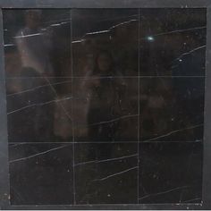 an image of a black and white marble tile with some cracks in it's surface