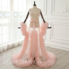 a mannequin is dressed up in pink feathers and tulle skirt with bows