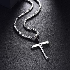 Faith is what determine ones mind, and distinguish him from others. Simplicity meets masculine and spiritual power for a sleek look. Made with white gold plated 925 sterling silver.Dimension: 40 mmLength: 22 inches Chain: Box Weight: 9.98gOrigin: Imported Cheap Cross Necklaces For Father's Day, Formal Silver Sterling Silver Cross Necklace, Silver Cross Necklace For Father's Day Gift, Father's Day Silver Box Chain Jewelry, Modern Silver Necklace With Cross Pendant, Elegant Father's Day Necklaces, Classic Silver Pendant Cross Necklace, Classic Silver Cross Pendant Necklace, Minimalist Silver Stainless Steel Cross Necklace