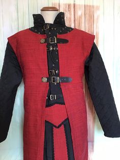 This unisex costume consists of 6 parts tin pants belt with strings behind adjustable, black decorations on red light quilted and studded legs, with adjustable leather buckles and laces Wide-textured raw fabric livery roughly sewn to the hem and frayed to give it a scruffy look hood with half a torn cloak at the hem and decorated with black trimetter colors you can choose at will ask availability The costume is ready in 3/4 weeks from purchase, contact me for any request Nerd Boyfriend, Light Quilt, Raw Fabric, Larp Costume, Role Playing Game, Fantasy Costumes, Leather Buckle, Red Light, Adult Costumes