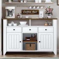 a coffee bar with white cabinets and wooden shelves