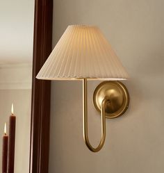 a wall light with a white shade on it