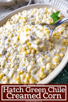 a white bowl filled with creamed corn and garnished with parsley