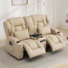 the reclining sofa has two cup holders on it