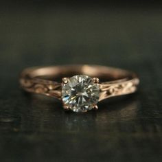 a close up of a ring with a diamond in it's center on a table