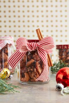 a glass jar filled with nuts and cinnamon sticks