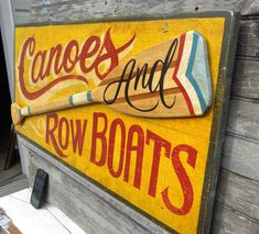 a wooden sign that says canoes and row boats