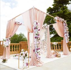 an outdoor wedding setup with pink and white flowers