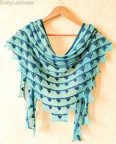 a blue shawl hanging on a wooden hanger