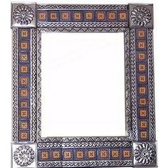 an ornate mirror with blue and gold designs on the edges, in front of a white background