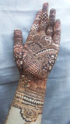 the hand is decorated with intricate designs on it