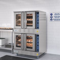 two large ovens with food inside of them in a kitchen next to a counter