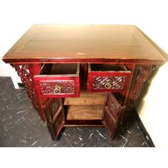 an ornate wooden cabinet with drawers on the bottom