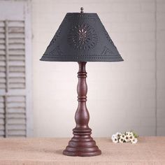 a wooden table lamp with a black shade