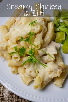 a white plate topped with pasta and broccoli on top of a woven table cloth