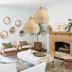 a living room filled with furniture and a fire place next to a wall mounted clock