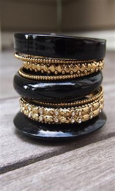 - Mix Stacked Bangles- 2.5" diameter- Separable- Black and gold- Weight: 0.24 lbs. Luxury Black Stackable Rings, Luxury Black Bangle, Luxury Stackable Brass Jewelry, Jewelry Black Gold, Cheap Traditional Stackable Jewelry, 90s Jewelry, Stacked Bangles, Stylish Jewelry, Gold Bangles