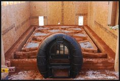 the inside of a building being built with bricks and cement in place to make it look like an oven