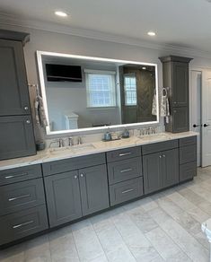 a large bathroom with double sinks and mirrors